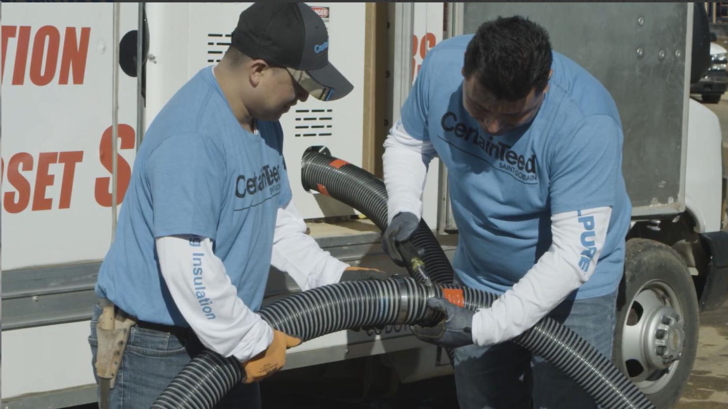 Two men assembling a hose